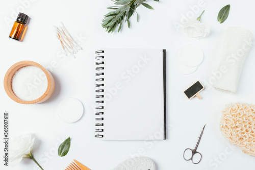 Blank notebook among natural organic cosmetics and body care accessories