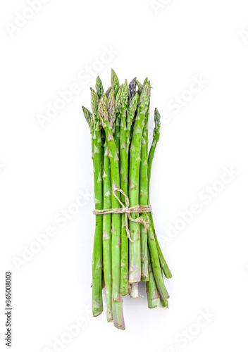 Bunch of fresh Asparagus on white background. Green raw sprouts of Asparagus Officinalis. Spring vegetables for healthy eating and lifestyle. Top View. Space for text.