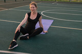 portrait of young beautiful caucasian woman doing workout on a basketball court