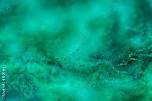 abstract blurred green sparkling background with swirls and waves, defocused background 