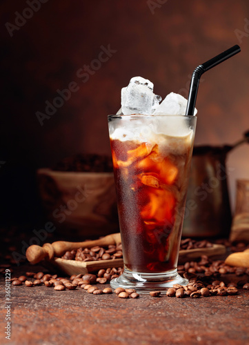Ice coffee with cream being poured into it showing the texture and refreshing look of the drink.