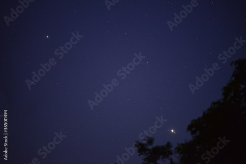 Jupiter and Saturn in the night sky with its four satellites 