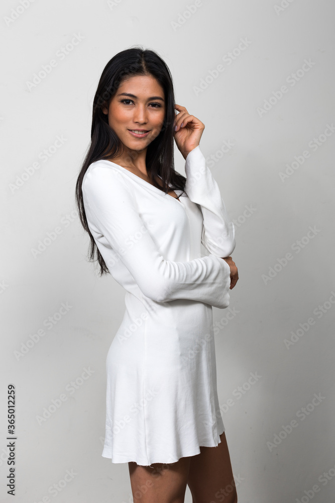 Portrait of young beautiful Asian woman against white background Portrait of young beautiful Asian woman against white background