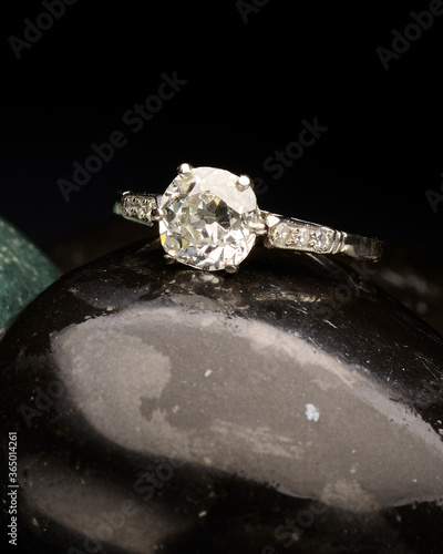 Classy silver ring close-up on top of grey stones photo