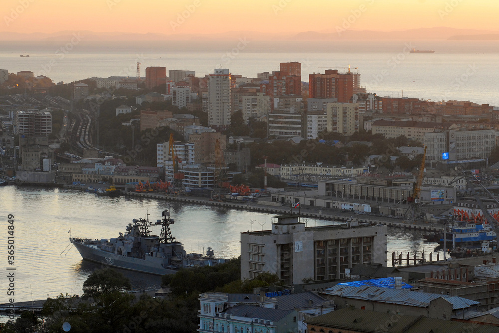 Sunset view at the centre of the city, harbour, warship, port and sea station. Vladivostok, Primorsky Krai (Primorye), Far East, Russia.