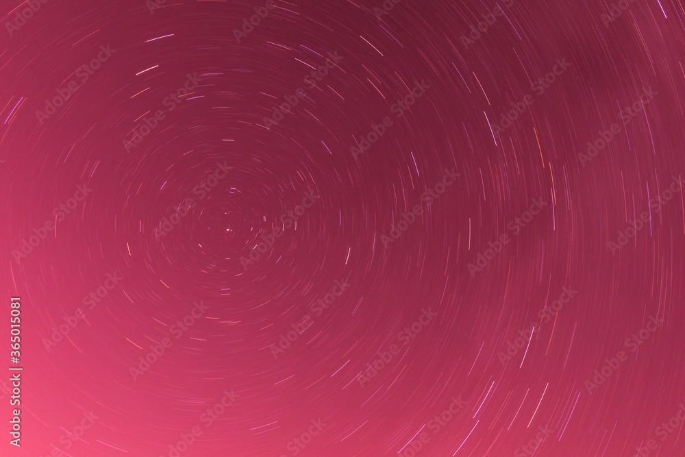 Background of round or circular star track or trajectory on the red, pink or rose clear night sky. Symbol of space, cosmos, expanse infinity and universe Background of round or circular star track or trajectory on the red, pink or rose clear night sky. Symbol of space, cosmos, expanse infinity and universe