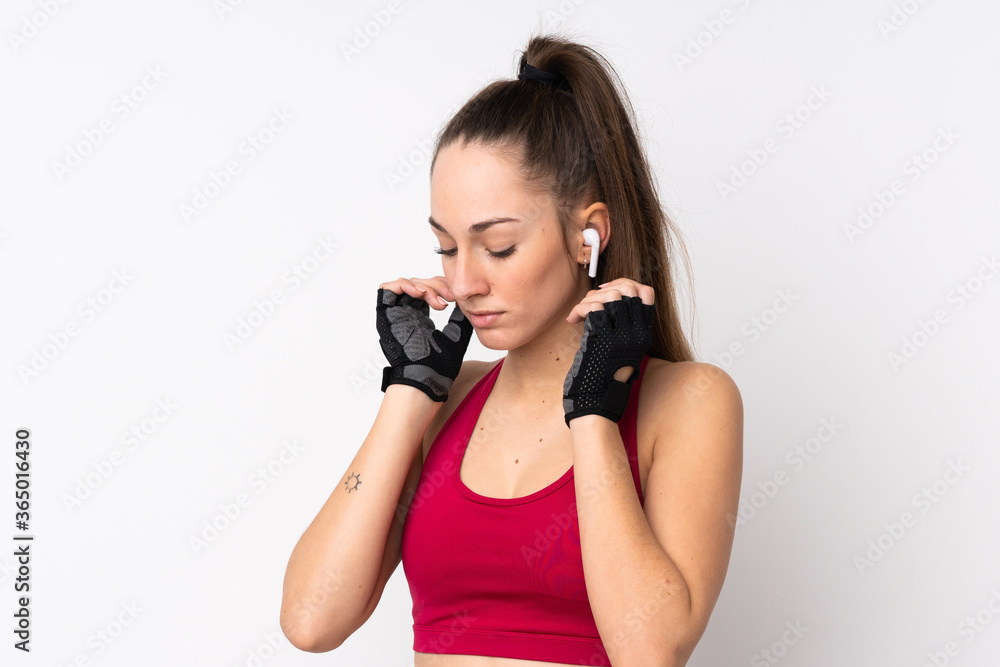 Young sport brunette woman over isolated white background listening music Young sport brunette woman over isolated white background listening music