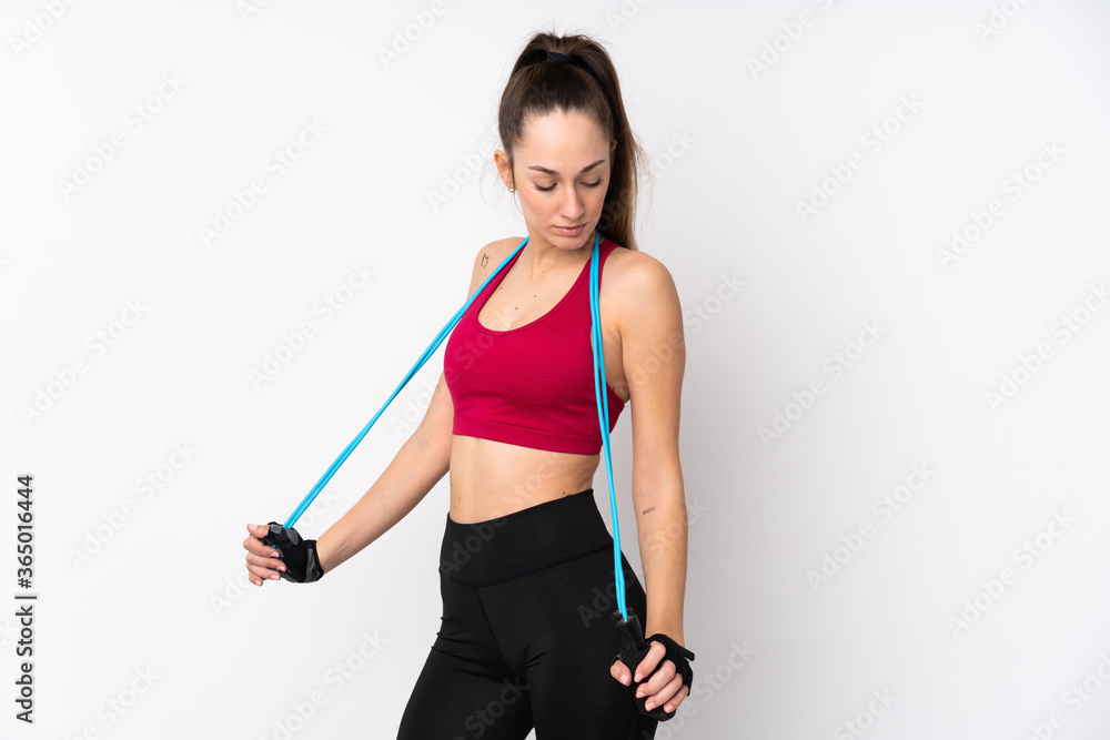 Young sport brunette woman over isolated white background with jumping rope Young sport brunette woman over isolated white background with jumping rope