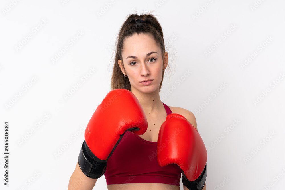 Young sport brunette woman over isolated white background with boxing gloves Young sport brunette woman over isolated white background with boxing gloves