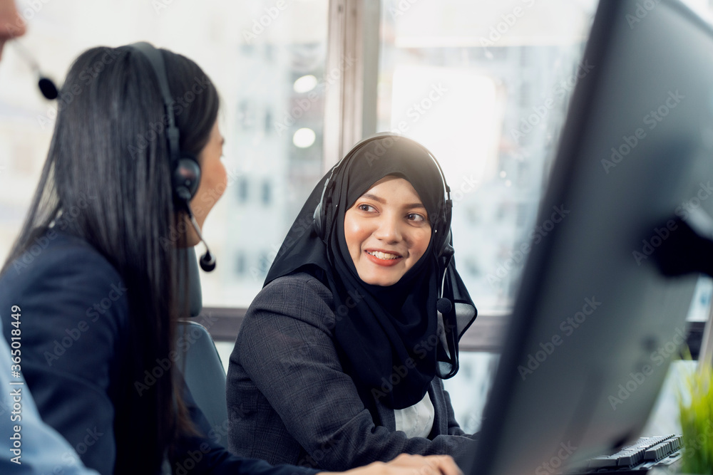 Muslim woman work as call center. Customer service executive working at office. Young friendly operator woman agent with headsets working in call centre. Clean office concept Muslim woman work as call center. Customer service executive working at office. Young friendly operator woman agent with headsets working in call centre. Clean office concept