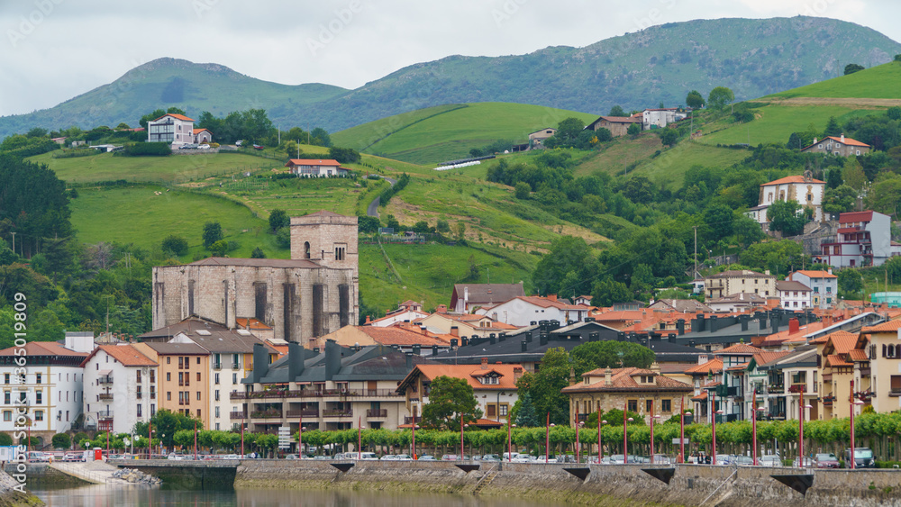 Small european town in the spanish Basque country. Zumaia is located between the mountains on the shores of the Atlantic Ocean. Mouth of the Urola River. Sun Pedro church.