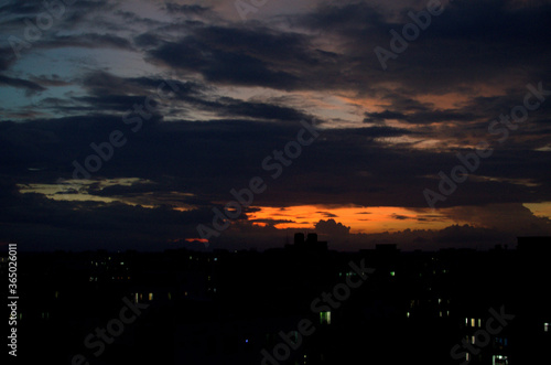 landscape shot of a cloudy sky at sunset with pink and orange clouds, in the county of Bangladesh. sunset in the city with shadows of buildings. 