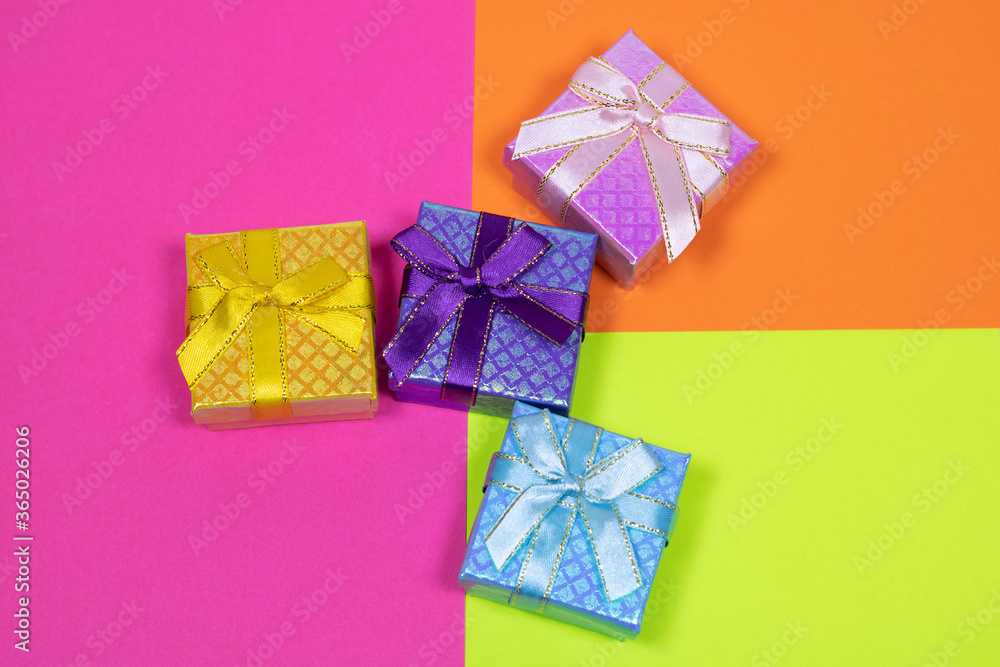 Gift on a multicolored background. Surprise in a festive package. Gift on a multicolored background. Surprise in a festive package.