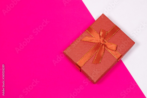 Gift on a multicolored background. Surprise in a festive package.