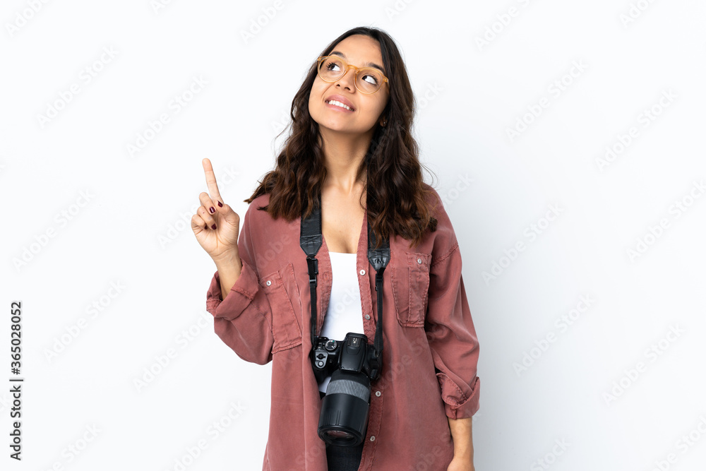 Young photographer woman over isolated white background pointing up a great idea Young photographer woman over isolated white background pointing up a great idea