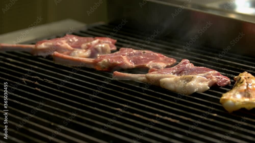 Chef preparing meat on grill. Cook grilling lambs ribs. Barbecue party concept. Chef preparing meat on grill. Cook grilling lambs ribs. Barbecue party concept.