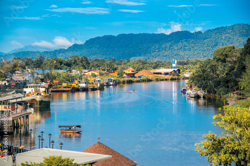 Lawas, Sarawak, Malaysia cityscape with river and mountain background