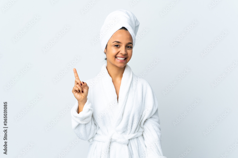 Young woman in bathrobe over isolated white background showing and lifting a finger in sign of the best Young woman in bathrobe over isolated white background showing and lifting a finger in sign of the best