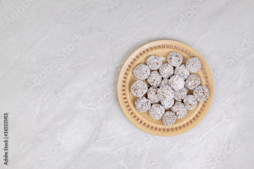 Energy Balls cookies with grated coconut served on the plate