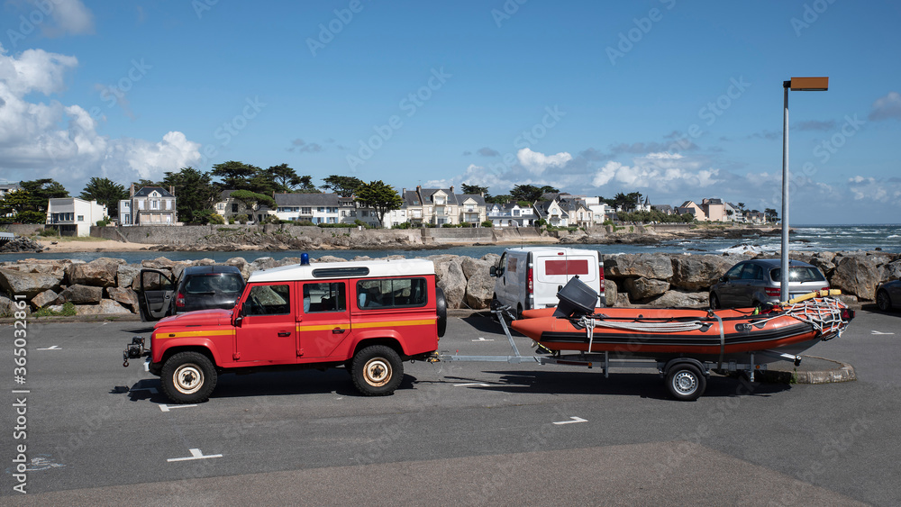 Boat and car of fireman and sea rescuer on the Brittany coast in France