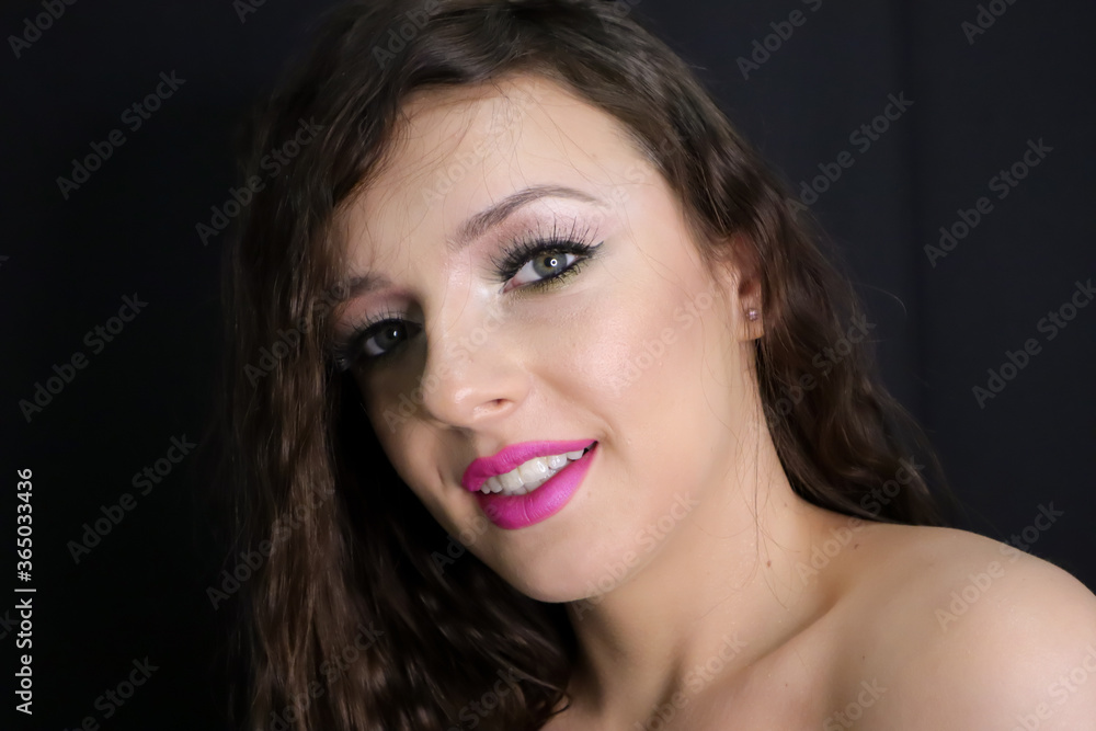 close up portrait of beautiful brunette young girl happily smiling, looking at camera with fresh make up on black background, pink lipstick curly hair over bare, naked shoulders, studio shot, close up portrait of beautiful brunette young girl happily smiling, looking at camera with fresh make up on black background, pink lipstick curly hair over bare, naked shoulders, studio shot,