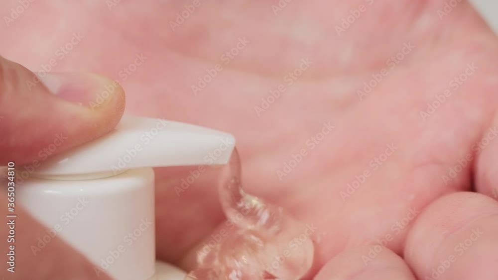 A man uses a sanitizer and washes his hands. close-up. A man uses a sanitizer and washes his hands. close-up.