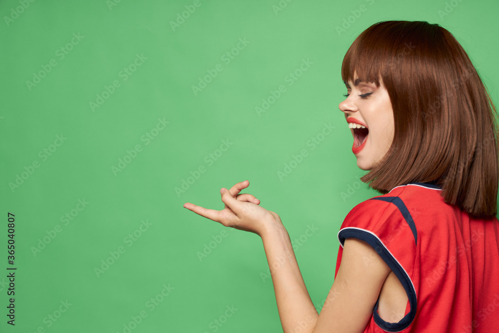 Woman with wide open mouth on a green background Woman with wide open mouth on a green background