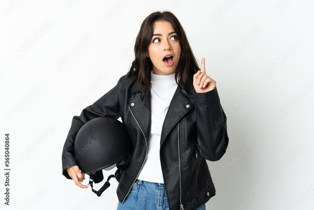 Woman holding a motorcycle helmet isolated on white background thinking an idea pointing the finger up Woman holding a motorcycle helmet isolated on white background thinking an idea pointing the finger up