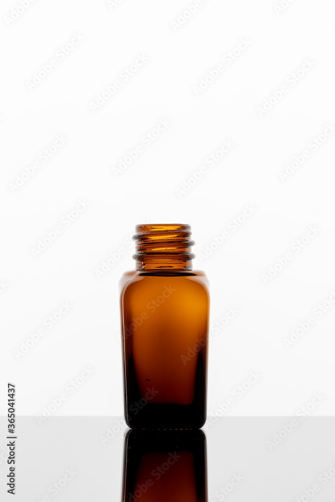 A bottle of essential oil on a white background