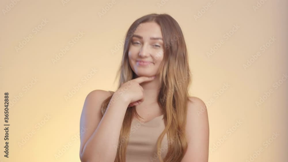 confident beautiful girl reacts on compliment and accepts it, woman embarrassed hesitated, female emotions on a studio background confident beautiful girl reacts on compliment and accepts it, woman embarrassed hesitated, female emotions on a studio background