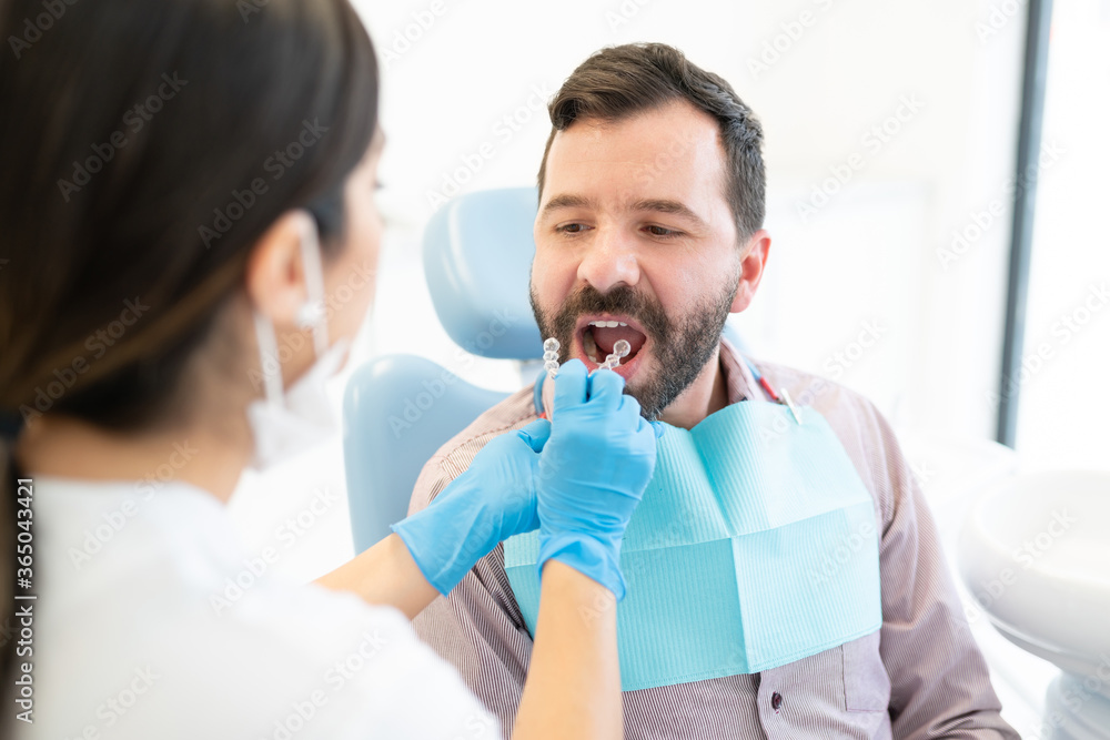 Obraz premium Dentist Examining Patient At Orthodontic Clinic