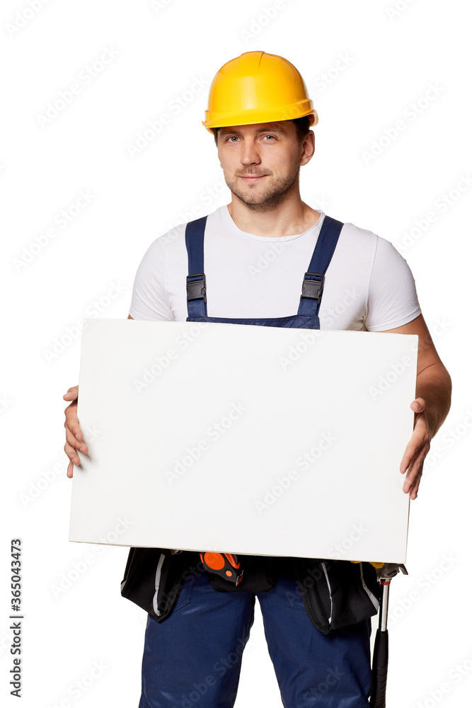 caucasian repairman worker in uniform and hard hat holding empty blank board. handyman wearing tool belt isolated on white studio background caucasian repairman worker in uniform and hard hat holding empty blank board. handyman wearing tool belt isolated on white studio background