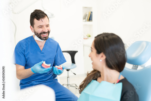 Smiling Orthodontist Discussing With Patient