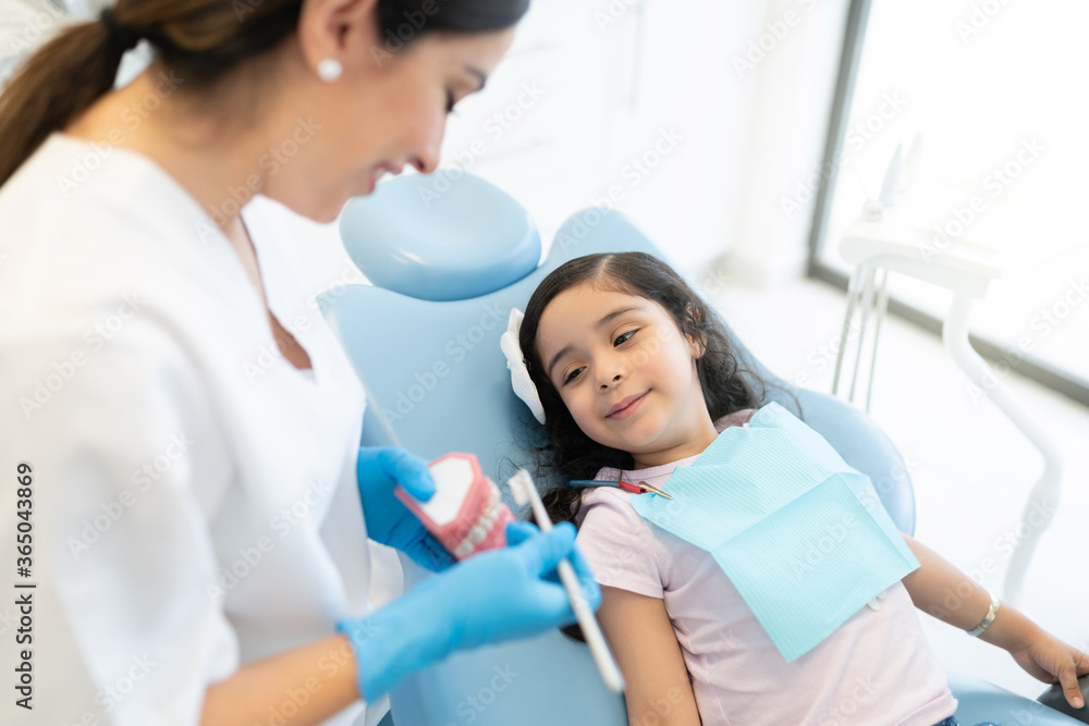 Teaching a girl how to brush her teeth Teaching a girl how to brush her teeth