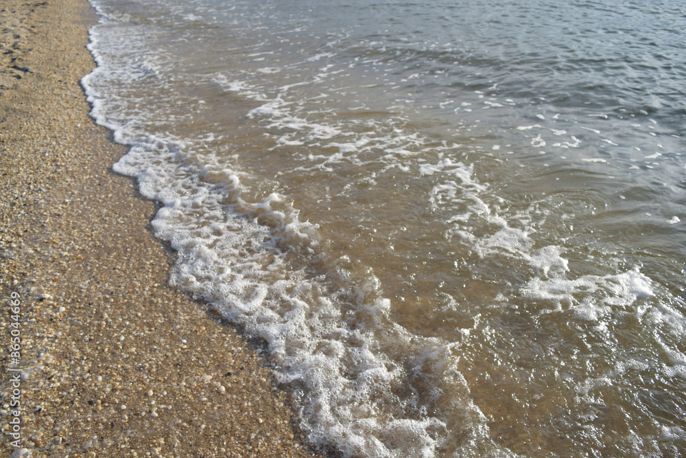 Waves Crashing on Sandy Beach with Seafoam Waves Crashing on Sandy Beach with Seafoam