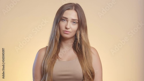 girl listens with a mock deception, female emotions of contempt and mistrust, woman face grimacing in communication