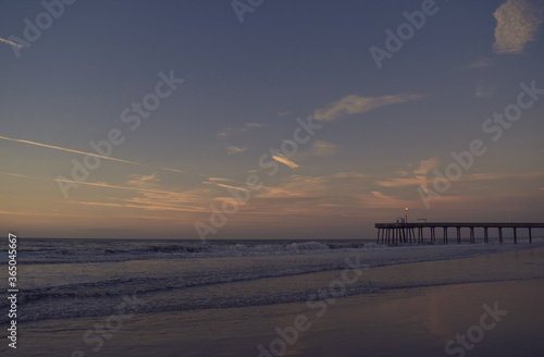 Fishing Pier in Ocean City NJ During Beach Sunrise Over the Ocean