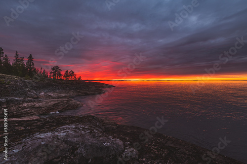 Colorful dramatic sunset at Ladoga Lake in Karelia, Russia.