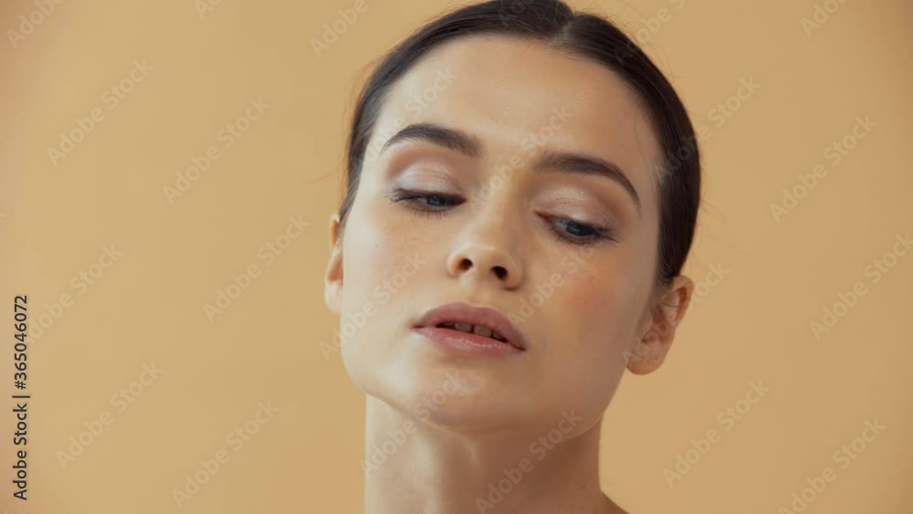 Beautiful naked woman smiling at camera isolated on beige Beautiful naked woman smiling at camera isolated on beige