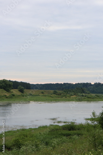 Cloudy day with clouds on the river in the countryside