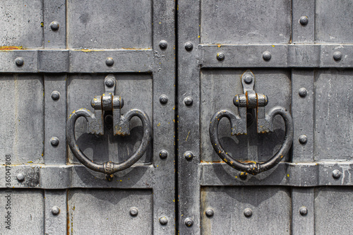 Iron handles on the metal-bound door