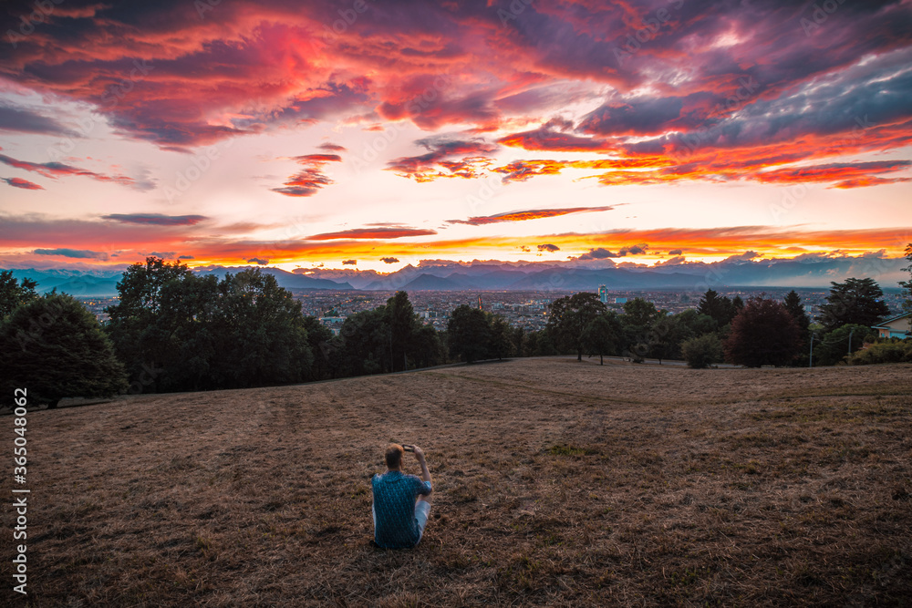 Man watching sunset sky panoramic view