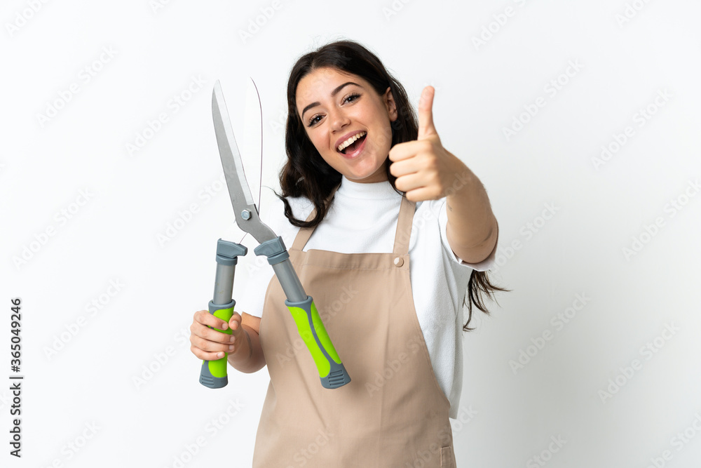 Young caucasian woman holding a plant isolated on white background with thumbs up because something good has happened Young caucasian woman holding a plant isolated on white background with thumbs up because something good has happened