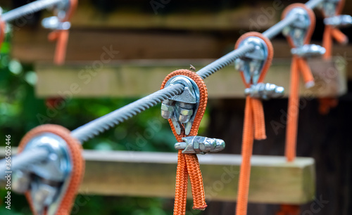 Rope holding a log bridge, part of the cableway. Close-up. Extreme sport.
