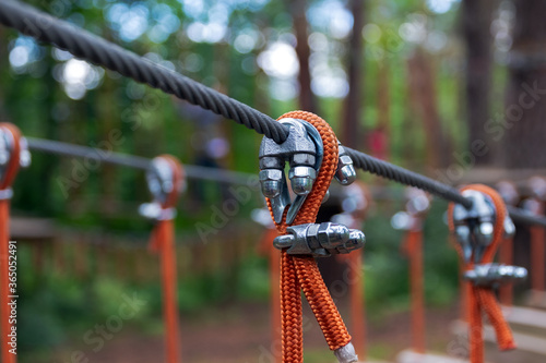 Rope holding a log bridge, part of the cableway. Close-up. Extreme sport.