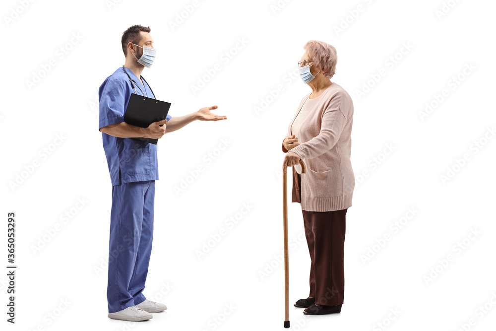 Elderly woman and a medical healthcare worker talking and wearing face masks Elderly woman and a medical healthcare worker talking and wearing face masks