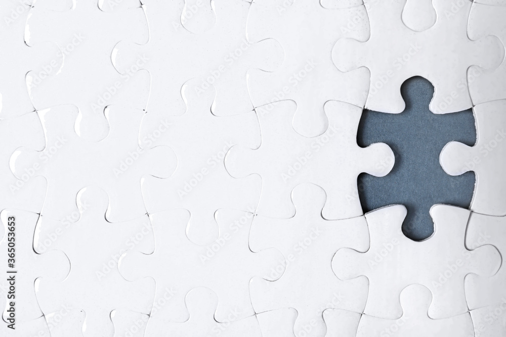 Fototapeta premium Blank white puzzle with missing piece on dark background, top view. Space for text