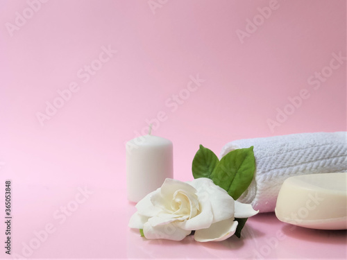 Spa setting and Spa background composition with white gardenia flower on pink background.