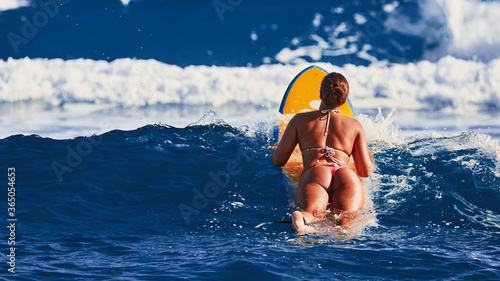 Surfer girl waiting for a wave. Surfer school. Beautiful young woman in swimsuit goes into ocean in hot summer day. Surfer on the wave. beautiful ocean wave. Water sport activity.