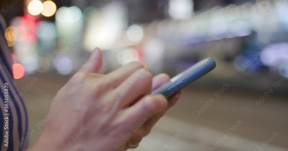Woman use of smart phone in city at night Woman use of smart phone in city at night